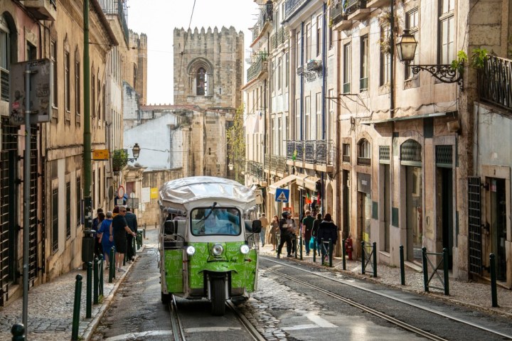 a group of people walking on a city street